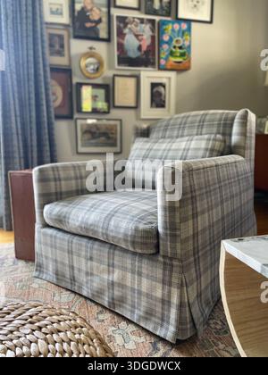 Sessel im Wohnzimmer mit gerahmten Bildern und Fotos Stockfoto