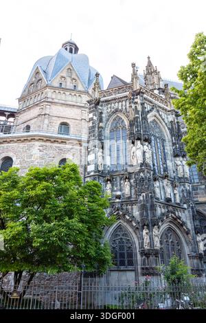 Komplizierte Steinschnitzereien und Statuen am gotischen Äußeren des Aachener Doms, Deutschland. Blick auf die kunstvolle Fassade und die achteckige Kuppel des UNESCO W Stockfoto