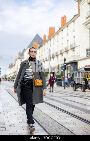Tours, Frankreich - 26. November 2021: Großer Blick auf die Einkaufsstraße Rue nationale mit Straßenbahnschienen und Weihnachtsgirlanden-Dekorationen in Tours France Stockfoto