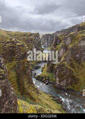 Dramatischer Fjaðrárgljúfur Canyon mit gewundenen Serpentinen und üppigen moosbedeckten Klippen, Südisland Stockfoto