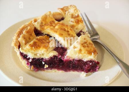 Ein Stück hausgemachter brombeertorte und Apfelkuchen auf einem Teller mit einer Gabel. Stockfoto