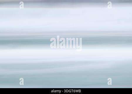 Ein beschauliches, hochkarätiges abstraktes Bild mit weichen horizontalen Streifen in Schieferblau und Nebelgrau. Die beabsichtigte Kamerabewegung erzeugt Stockfoto
