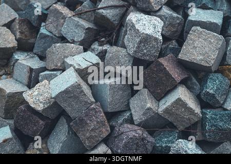 Ein Haufen von rauem Granit mit Kopfsteinpflastersteinen blockiert die Nahtextur Stockfoto