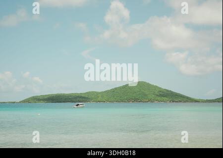 Kleines Boot schwimmt auf türkisfarbenem Wasser in Playa Sardinas, Culebra Stockfoto