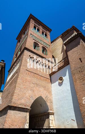 Glockenturm im Mudéjar-Stil der Kirche San Pedro mit kompliziertem Ziegelwerk und glasierten Fliesen unter blauem Himmel. Stockfoto