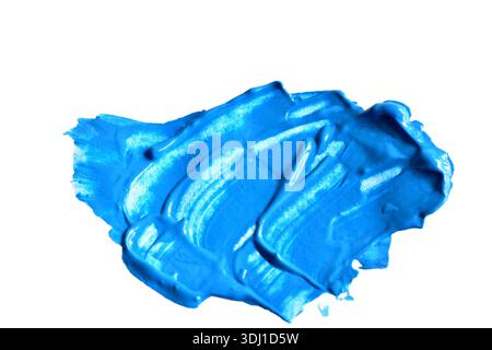 Ein Fleck blauer Farbe auf weißem Hintergrund. Stockfoto