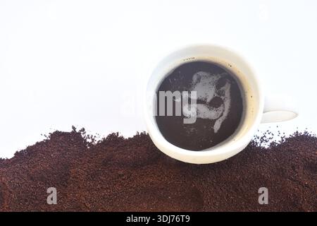 Schwarze heiße Kaffeetasse und gemahlen isoliert auf weißem Hintergrund Stockfoto