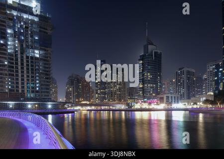Dubai Marina, Vereinigte Arabische Emirate - 13. März 2025: Dubai Marina verfügt über moderne Wolkenkratzer, die bei Nacht beleuchtet werden und sich auf der Wasseroberfläche wi spiegeln Stockfoto