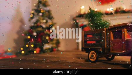 Ein hölzerner Spielzeugwagen mit Tannenzweig auf der Tischplatte, Weihnachtsbaum, Girlande, Konfetti, Kopierraum Stockfoto