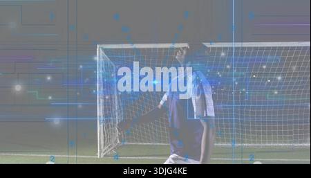 Stehender Fußballspieler in leichten, zweifarbigen Trikots auf dem Nachtfeld, in der Nähe des Tornetzes, AR-Grafiken Stockfoto