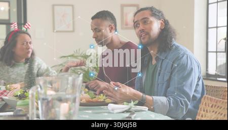 Sprechender Mann, der ein Jeansshirt trägt und Besteck am Esstisch hält, mit Platte, Überzug, Kopierraum Stockfoto