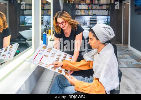 Friseur und Kunde wählen die Haarfarbe im Salon Stockfoto