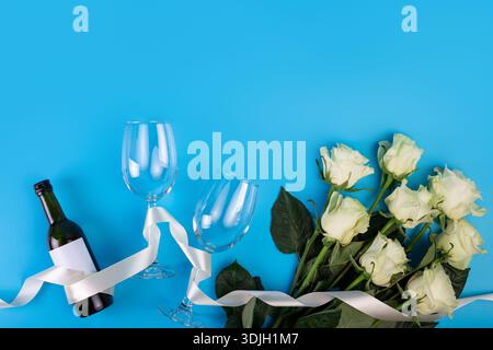 Foto von oben vom romantischen Abend, Dinner Dekor Herzen lieben Weingläser mit Konfetti Weinflasche und weißem Band mit großen Strauß weißer Rosen Stockfoto