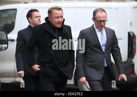 Michael Flatley (centre) leaving Belfast High Court, after a legal order blocking him from engaging with the Lord of the Dance production has been overturned. At The Chancery Court in the Royal Courts of Justice on Thursday, Mr Justice Simpson discharged a temporary injunction that had been secured against the dancer and choreographer. Picture date: Thursday January 29, 2026. Stockfoto
