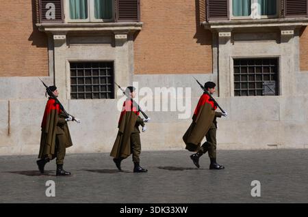 Zeremonielle Wachen marschieren in Formation entlang einer Straße in Vatikanstadt, Rom, Italien Stockfoto