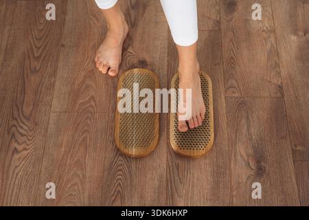 Nahaufnahme der Beine der Frau, die auf Nägeln stehen. Stockfoto