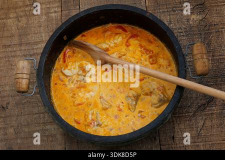 Fischeintopf oder Moqueca de Peixe auf Portugiesisch, typisch brasilianisches Gericht, in einem Tontopf auf schwarzem Stein. Sao Paulo, Brasilien Stockfoto
