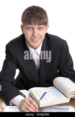 Lächelnder Student sitzt mit den Büchern Stockfoto