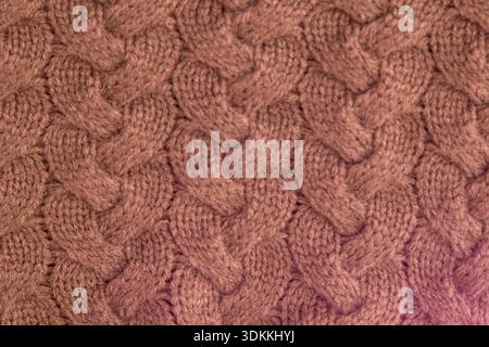 Rosa Zopfstrick Stoff Wolle Pullover Hintergrund. Stockfoto