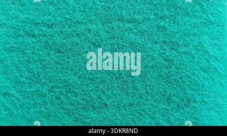 Nahaufnahme Makroaufnahme des Texturhintergrunds mit grünem Scheuerschwamm und verwickelten Fasern Stockfoto