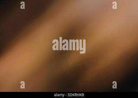 Ein unscharfes abstraktes Bild mit einer Mischung aus warmen Braun- und Orangetönen, die einen weichen Farbverlauf erzeugen Stockfoto