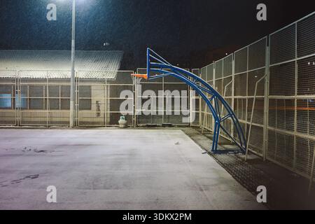 Leeres Basketballfeld in der Nacht, im Februar in Serbien mit Schnee bedeckt. Stockfoto