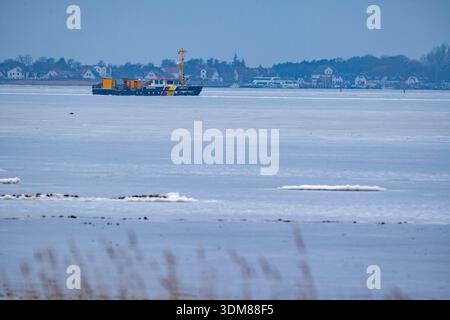 Schaprode, Deutschland. Februar 2026. Das Mehrzweckschiff und Eisbrecher „Görmitz“ vom Ostseeamt fährt durch das Eis vor der Insel Hiddensee. Das 8,68 Meter breite Schiff fährt in einem Kanal. Im Hintergrund ist das Dorf Vitte auf der Insel Hiddensee zu sehen. Quelle: Stefan sauer/dpa/Alamy Live News Stockfoto