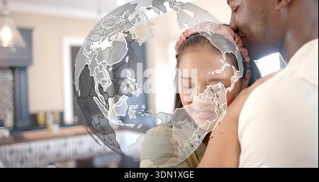 Legenes Paar, das in der Küche kuschelt, in T-Stück und Stirnband, mit Globus-Überzug, Ablagefläche für Hängeanhänger Stockfoto