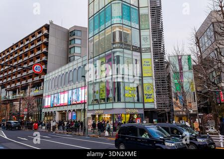 Die urbane Tokio-Szene zeigt schwarze Taxis und Shopper im Modeviertel Omotesando Stockfoto