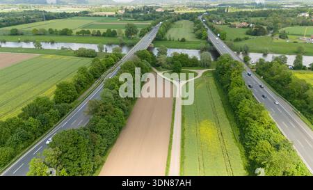 Zwei Autobahnen oder Autobahnen über Felder mit Mais und Weizen. Drohne schöne Aussicht auf die deutsche Landschaft am Sommertag. Stockfoto