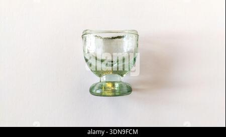 Augenspülbecher aus Glas isoliert auf weißem Hintergrund. Vintage Augenspülbecher aus transparentem Glas. Medizinkonzept Stockfoto
