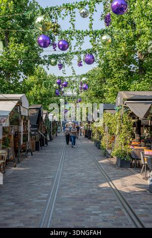 Paris - Frankreich,Frankreich - 08 15 2025: Panoramablick auf den Innenhof von Saint-Emilion im Bercy Village, der an sonnigen Tagen mit bunten Ballons dekoriert ist Stockfoto