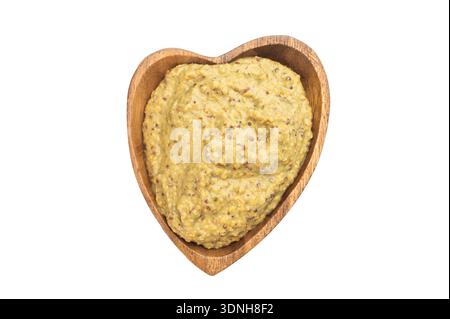 Traditioneller deutscher bayerischer Senf süß und mild serviert in einer Holzschale über dem Zimmer auf einem dunklen rustikalen Holztisch. Stockfoto
