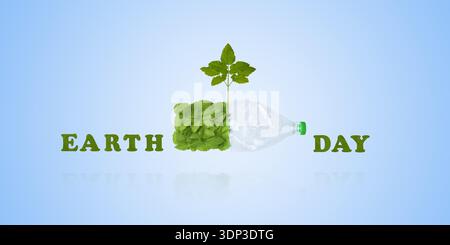 Plastikflasche und grüne Blätter auf blauem Hintergrund. Vermeiden Sie Kunststoffverschmutzung. Earth Day 2026 Konzept und umweltverträgliches Recycling. Ökologisches Konzept. Stockfoto