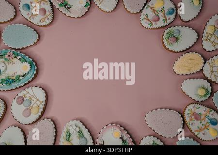 Ein Rand aus dekorierten Ostereierkeksen auf rosa Hintergrund Stockfoto