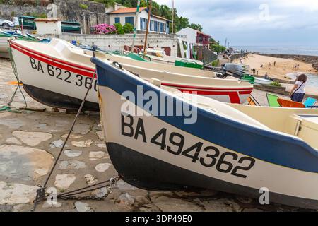 Angedockte Boote säumen ein malerisches Dorf am Meer, bereit für das nächste Abenteuer. Stockfoto