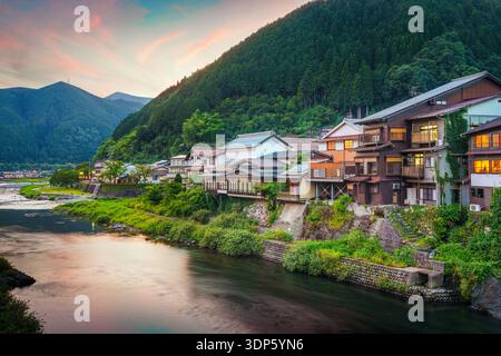 Gujo Hachiman, Japans heiße Quellen in der Abenddämmerung über dem Yoshida River. Stockfoto