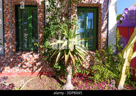 Santa Barbara, Kalifornien - 29. Dezember 2025: Detaillierte gemusterte Fliesen rahmen grüne Fenster eines mediterranen Gebäudes in Santa Barbara, Kalifornien. Stockfoto