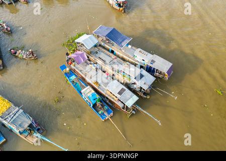 Cai Rang, Vietnam - 19. Januar 2020: Aus der Vogelperspektive auf mehreren Holzbooten, die sich auf dem Fluss ansammeln, mit sichtbaren Gütern, Planen und Solarpaneelen auf dem schwimmenden Markt Cai Rang. Stockfoto