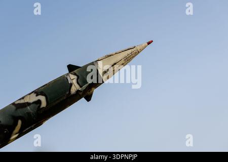 Hanoi, Vietnam - 9. Januar 2020: Nahaufnahme des Nasenabschnitts einer Rakete mit Tarnfarbe, ausgestellt im Freien im B-52 Victory Museum, mit einem klaren blauen Himmel im Hintergrund. Stockfoto