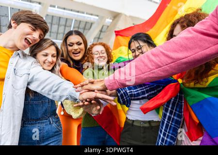 Gruppe von Freunden, die sich bei LGBT Pride an die Hand nehmen Stockfoto