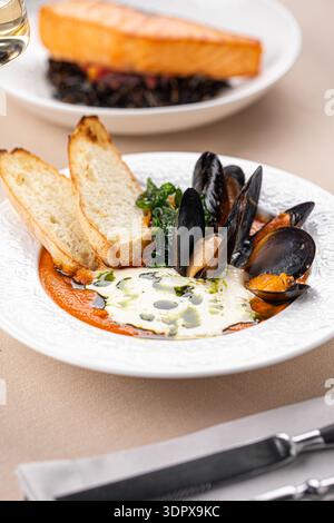 Muschelsuppe und Lachs mit Wildreis Stockfoto