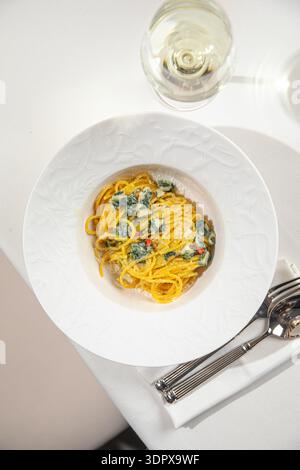 Cremige Spinatnudeln in weißer Schüssel Stockfoto