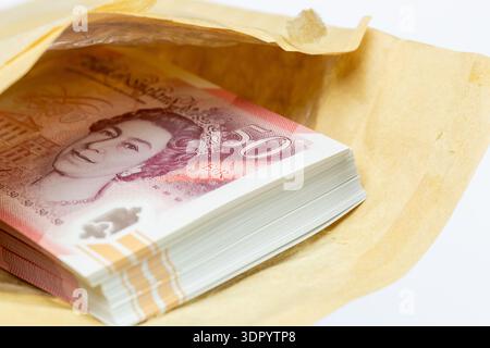 Eine Nahaufnahme eines braunen Umschlags, der einen Stapel fünfzig Pfund-Noten enthält. Stockfoto