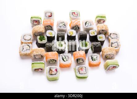 Verschiedene Sushi Rolls auf weißem Hintergrund in einem farbenfrohen Display für Feinschmecker Stockfoto