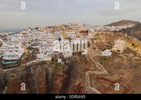 Fantastischer Blick aus der Vogelperspektive auf das Dorf oia in santorini traditionelle weiße Häuser Windmühlen vulkanische Klippen Stockfoto