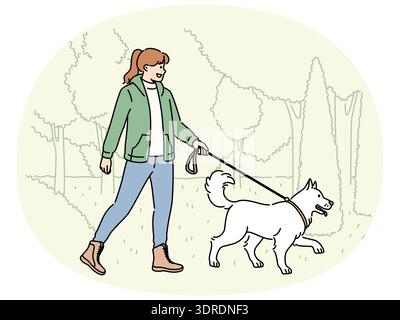 Lächelnde Frau, die mit Hund im Park läuft Stockfoto
