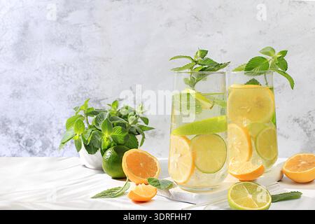 Diät veganer Cocktail mit Zitrusfrüchten, Entgiftungswasser, Mojito mit Zitrone, Limette, Orange, Minze und grüner Apfel. Detox-Diät und Gewichtsverlust Stockfoto