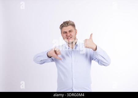Mann in blauem Hemd, der mit Daumen auf sich zeigt Stockfoto