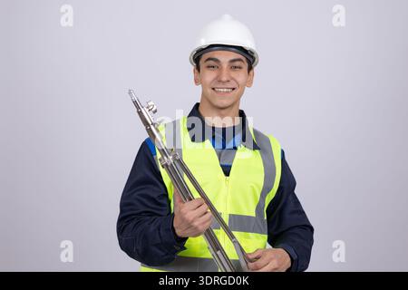 Techniker, der ein großes Metallrohr oder Teil hält Stockfoto